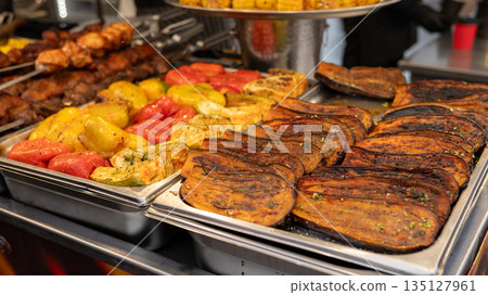 Assorted grilled vegetables and meats displayed on trays at a market stall National Brisket Day Assorted grilled vegetables and meats displayed on trays at a market stall National Brisket Day 135127961