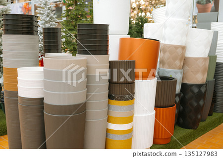 Assorted colorful flower pots in garden setting Assorted colorful flower pots in garden setting 135127983
