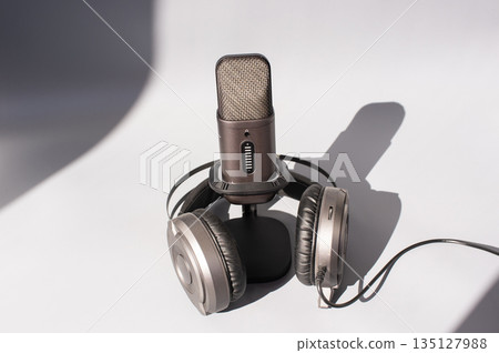 Studio microphone and headphones on white background 135127988