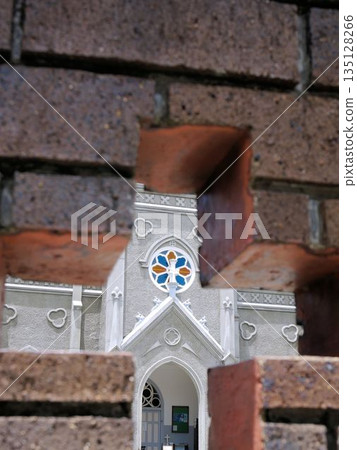 Cross window: Sakitsu Cathedral seen beyond the block wall (Amakusa City, Kumamoto Prefecture) 135128266