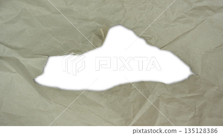 Torn paper hole with rough edges on crumpled paper background. Abstract ripped paper frame with irregular tear shape and visible paper texture. Design element for overlays, backgrounds, posters 135128386