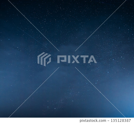 Starry night sky with wispy clouds and nebula Starry night sky with wispy clouds and nebula 135128387