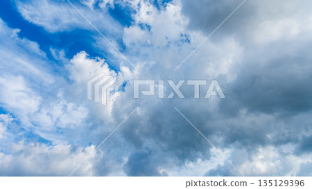 Many white clouds flowing in the summer blue sky 135129396