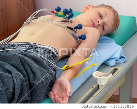 Child undergoing electrocardiogram examination in medical clinic Child undergoing electrocardiogram examination in medical clinic 135132039