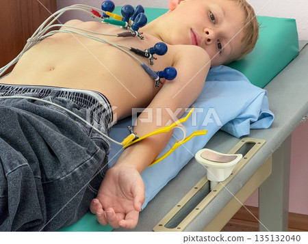 Child undergoing electrocardiogram examination in medical clinic Child undergoing electrocardiogram examination in medical clinic 135132040
