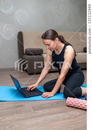 Home workout with dumbbells, foam roller, resistance band and yoga mat 135132949