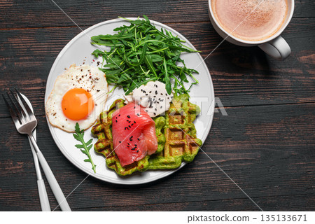 Healthy breakfast with green spinach waffles, salmon, cream cheese, fried egg and salad Healthy breakfast with green spinach waffles, salmon, cream cheese, fried egg and salad 135133671