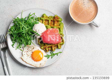 Healthy breakfast with green spinach waffles, salmon, cream cheese, fried egg and salad Healthy breakfast with green spinach waffles, salmon, cream cheese, fried egg and salad 135133699