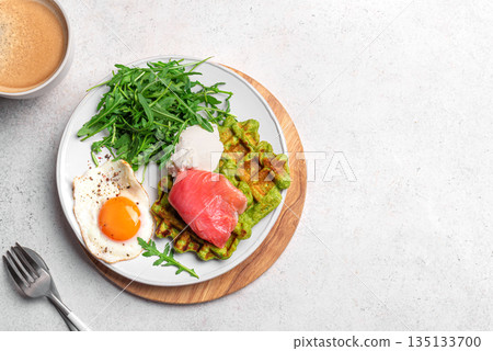 Healthy breakfast with green spinach waffles, salmon, cream cheese, fried egg and salad Healthy breakfast with green spinach waffles, salmon, cream cheese, fried egg and salad 135133700