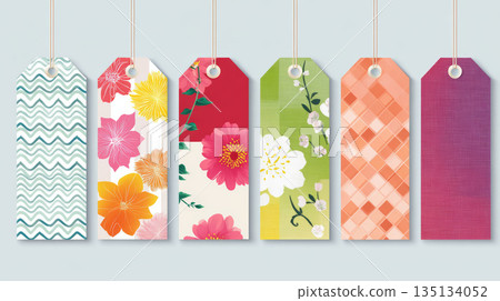 Floral and geometric patterned gift tags with string, featuring colorful flowers and abstract designs in various shades 135134052