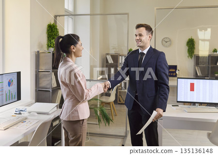 Business team handshake in modern office after successful agreement and partnership 135136148