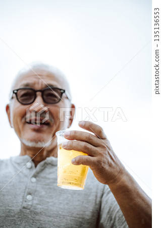 A man holding a beer (Photo courtesy of Oki Seaside Resort Miyabi) 135136553