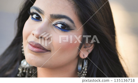 Smiling Bangladeshi girl portrait with blue eyeliner makeup and ethnic jewelry in Moscow Smiling Bangladeshi girl portrait with blue eyeliner makeup and ethnic jewelry in Moscow 135136718