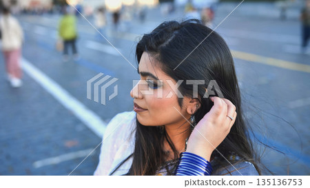 Bangladeshi woman looking away on a city street, exploring Moscow, Russia 135136753
