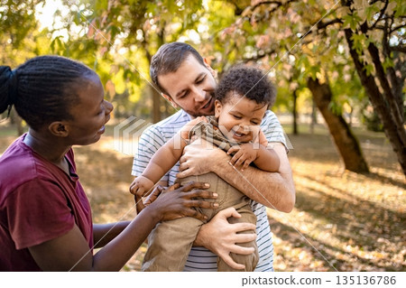 Joyful family moment capturing love in an autumn park setting 135136786