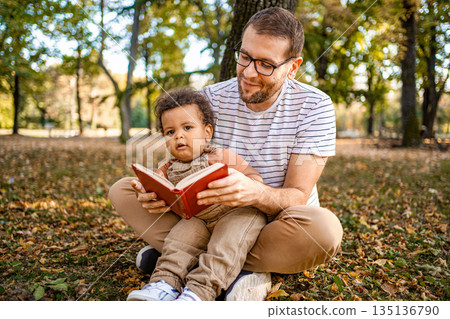 Enjoying a cozy reading moment in the autumn park Enjoying a cozy reading moment in the autumn park 135136790