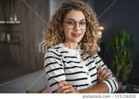 Woman With Glasses Standing in Front of a Couch 135136850