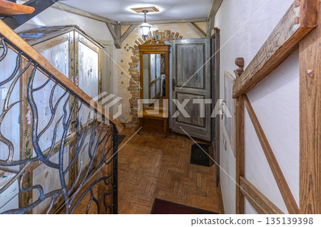 Rustic Hallway Interior with Wooden Staircase and Vintage Mirror Rustic Hallway Interior with Wooden Staircase and Vintage Mirror 135139398