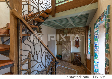 Rustic Interior with Wooden Staircase, Brick Wall and Vintage Clock 135139400