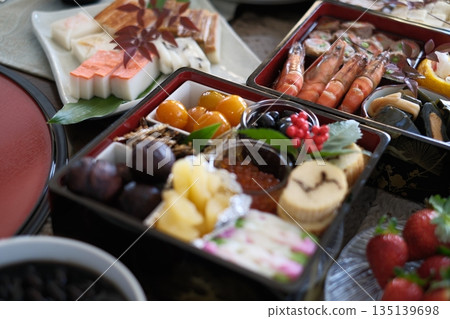 A dining table lined with New Year's dishes prepared by the family A dining table lined with New Year's dishes prepared by the family 135139698