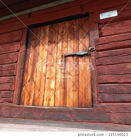 The enter door Porch. Old wooden red houses of past centuries in Norrbotten, the ancient capital of Sweden. 1700 years. 135140023