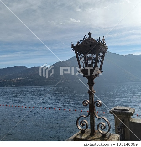 Como Lake landscape. Street Lamp, mountains and water. Bellagio Italy 135140069