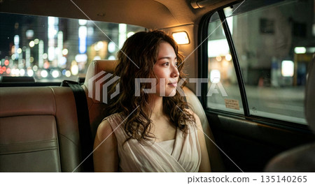 Woman sitting in the back seat of a taxi Woman sitting in the back seat of a taxi 135140265