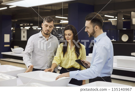 Consultant Assisting Couple In Plumbing Store 135140967