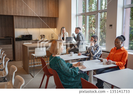 Group of People Sitting Around Table in Room 135141733