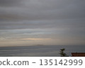 Seascape of cloudy sunrise sky, island and sea surface Seascape of cloudy sunrise sky, island and sea surface 135142999