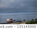 A view of Cebu Island with the resort coastline, blue ocean, islands, mountains on the opposite shore, and a cloudy sky A view of Cebu Island with the resort coastline, blue ocean, islands, mountains on the opposite shore, and a cloudy sky 135143000