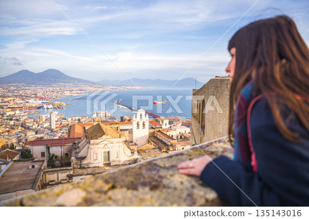Woman gazes at Naples Italy with Mount Vesuvius in the background 135143016