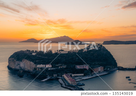 Coastal town buildings at sunset with mountains in the background. Nisida, Naples Coastal town buildings at sunset with mountains in the background. Nisida, Naples 135143019