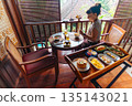 Woman enjoys a delicious breakfast on a balcony, a perfect start to the day, Bali, Indonesia 135143021