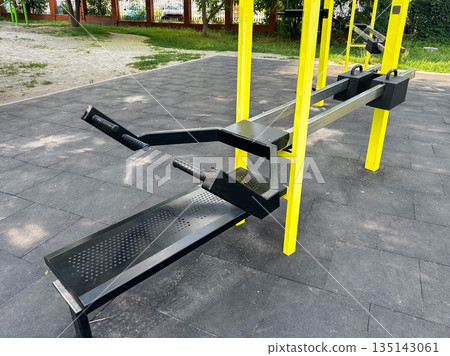Outdoor gym equipment in a public park for fitness and exercise. Outdoor gym equipment in a public park for fitness and exercise. 135143061