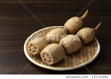 Lotus root on a tray with a wooden background Lotus root on a tray with a wooden background 135143092