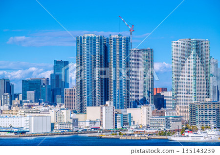 Tokyo cityscape in Japan. View of Harumi, Shoyomaru, and tower apartment buildings in the Toyomi area. Nihonbashi redevelopment project in the background on the left. 135143239