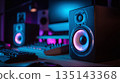 Neon-lit studio setup with professional audio speakers, keyboard, and mixing console. Perfect for music production, sound design, and creative audio projects. 135143368