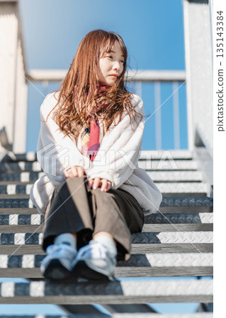 Women sitting on the stairs Women sitting on the stairs 135143384