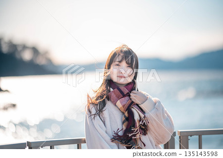 young woman standing on the beach 135143598