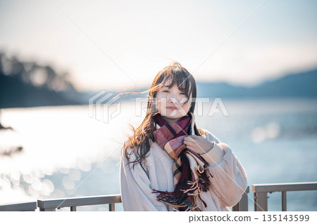 young woman standing on the beach 135143599