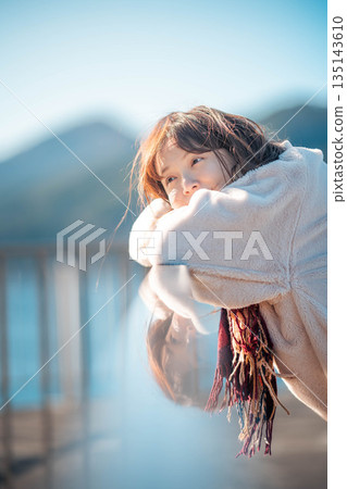 young woman standing on the beach 135143610