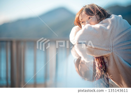 young woman standing on the beach 135143611