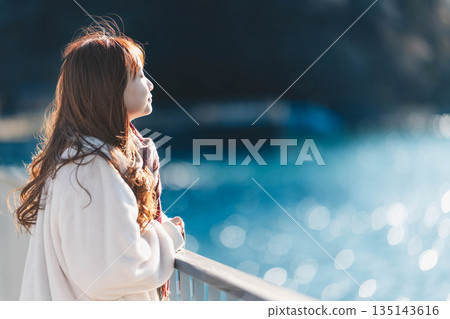 young woman standing on the beach 135143616