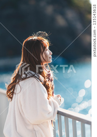 young woman standing on the beach 135143618
