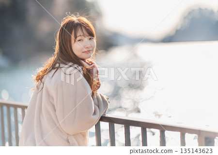 young woman standing on the beach 135143623