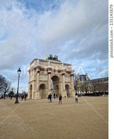 Paris, France - December 10, 2025: the Arc de Triomphe du Carrousel reveals the intricate marble columns of neoclassical architecture and golden Quadriga statue atop the monument Paris, France - December 10, 2025: the Arc de Triomphe du Carrousel reveals the intricate marble columns of neoclassical architecture and golden Quadriga statue atop the monument 135143879