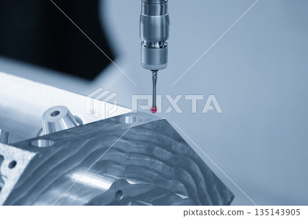 The multi-axis CMM machine measuring the aluminum cylinder head parts in the light blue scene. The multi-axis CMM machine measuring the aluminum cylinder head parts in the light blue scene. 135143905