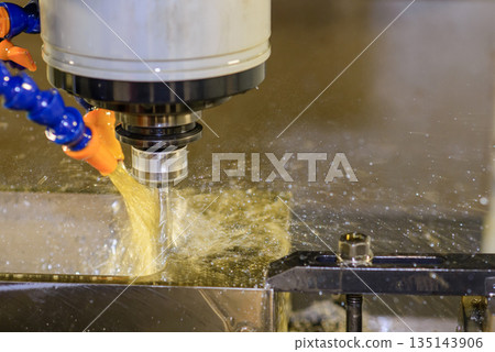 Close up scene the CNC milling machine finishing cut the mold parts with oil coolant method. Close up scene the CNC milling machine finishing cut the mold parts with oil coolant method. 135143906