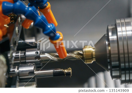 The multi tasking CNC lathe machine Swiss type drilling process the brass coupling parts. 135143909
